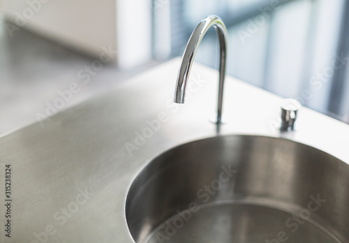 Modern, simple stainless steel kitchen sink and faucet