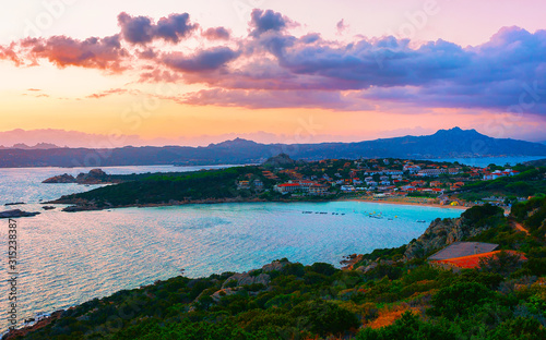 Landscape and scenery of Baja Sardinia luxury resort in Costa Smeralda at sunset evening, Sardegna island in Italy in summer. Olbia province. Villas And Mediterranean sea. Mixed media. © Roman Babakin