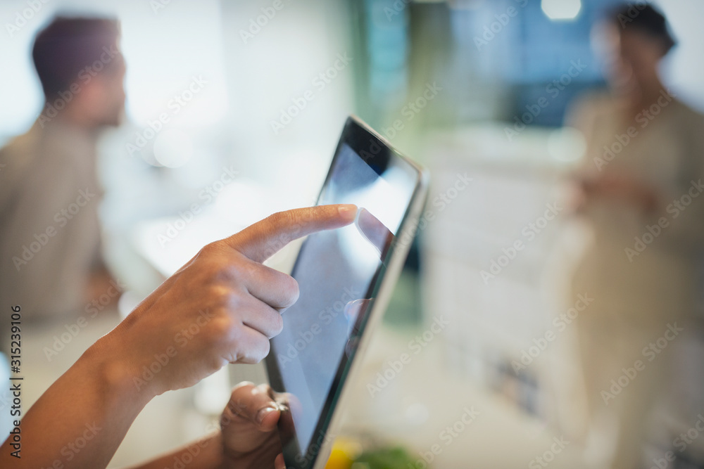 © Tom Merton/Caia Image - Close up businessman touching digital tablet