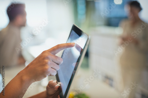 Close up businessman touching digital tablet