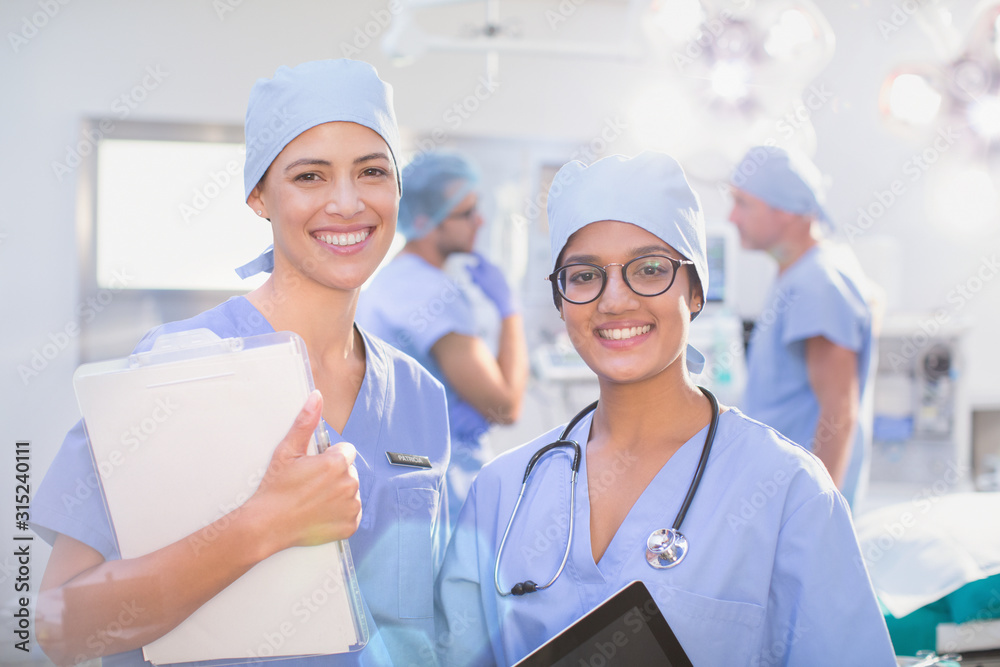 Portrait smiling, confident female surgeons in operating room Portrait smiling, confident female surgeons in operating room