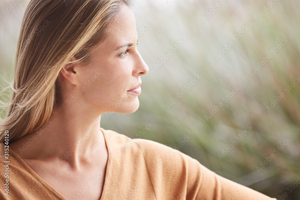 Close up pensive blonde woman looking away Close up pensive blonde woman looking away