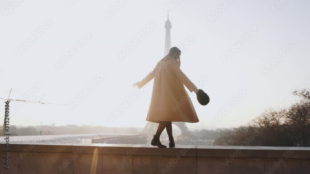 Side view beautiful happy tourist woman walking, dancing at romantic sunrise Eiffel Tower scenery in Paris slow motion.