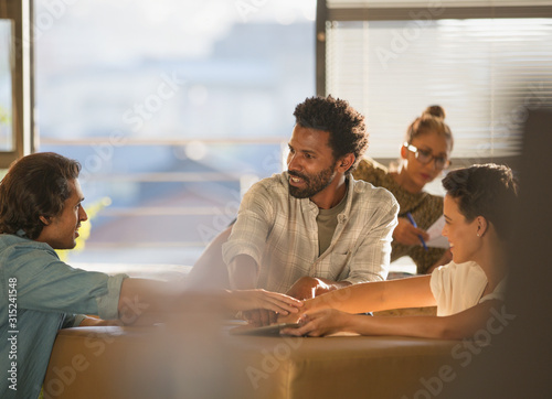 Creative business people connecting hands in huddle