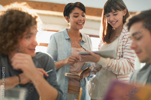 Young friend college students studying with digital tablet
