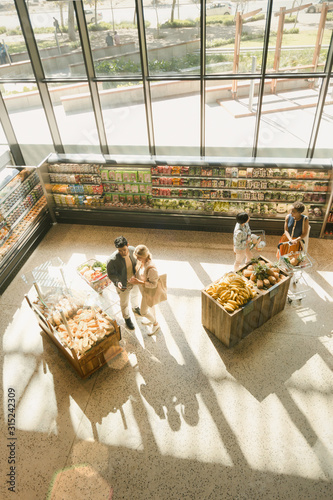 High angle view people grocery shopping in market photo