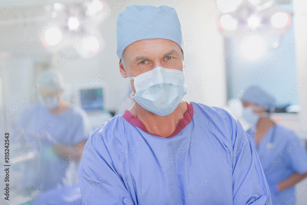 Portrait confident mature male surgeon in operating room Portrait confident mature male surgeon in operating room