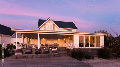 Tranquil white home showcase exterior at dusk photo