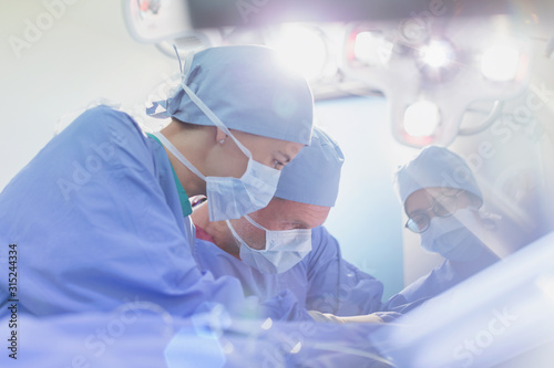 Focused surgeons performing surgery in operating room
