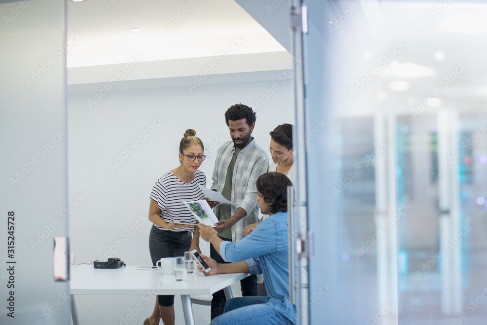 Creative business people discussing paperwork in conference room meeting Creative business people discussing paperwork in conference room meeting