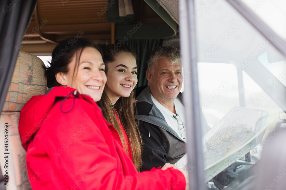 Portrait happy family with map in motor home Portrait happy family with map in motor home