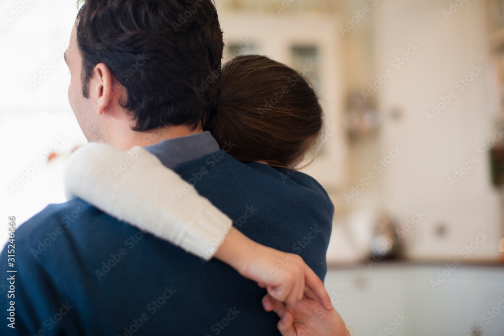 Affectionate father and daughter hugging Affectionate father and daughter hugging