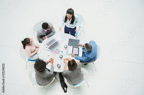 High angle view businesswoman leading meeting at round table