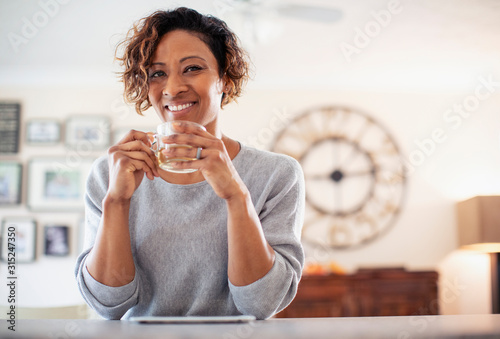 Portrait smiling, confident woman drinking tea photo