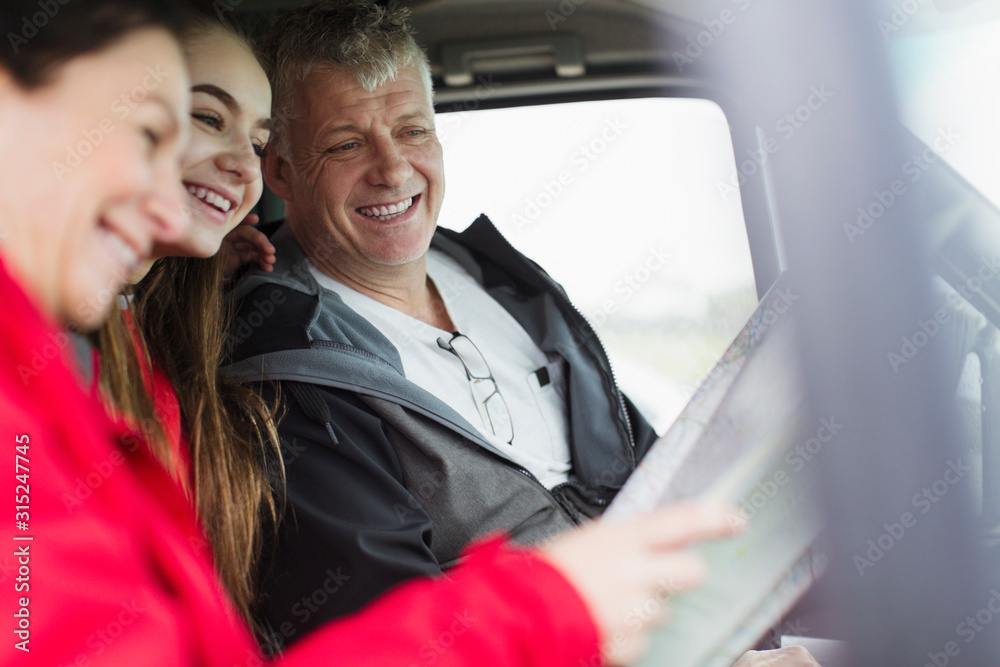 Parents and daughter looking at map in motor home Parents and daughter looking at map in motor home