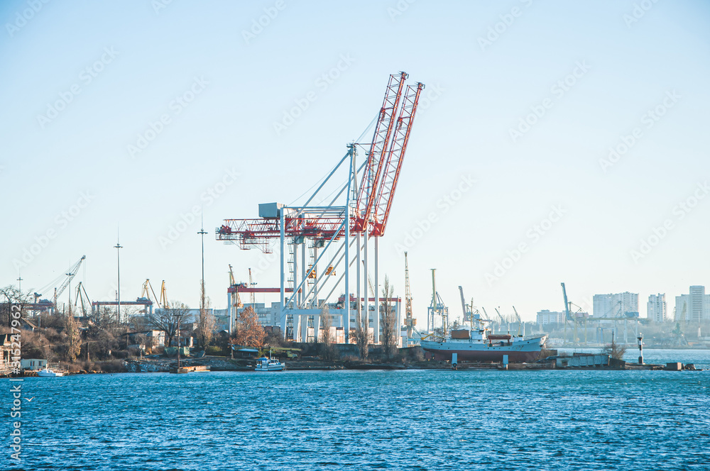 Large industrial cranes for loading onto ships in a seaport.