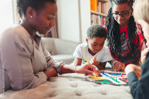 Multi-generation family playing board game