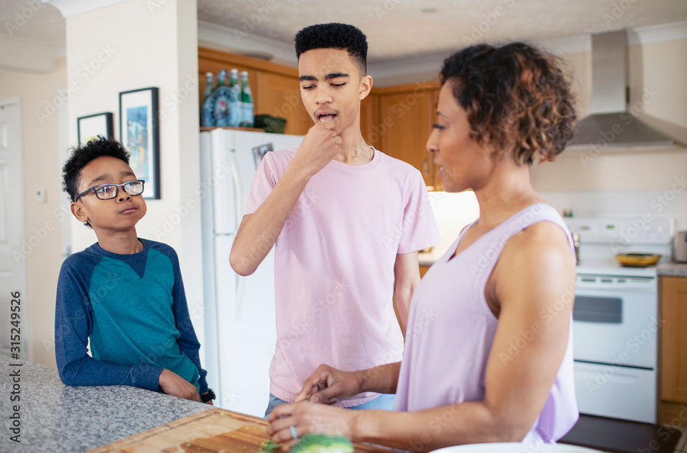 Mother and sons cooking in kitchen Mother and sons cooking in kitchen