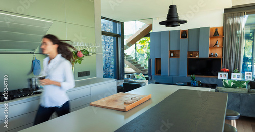 Woman walking in modern kitchen