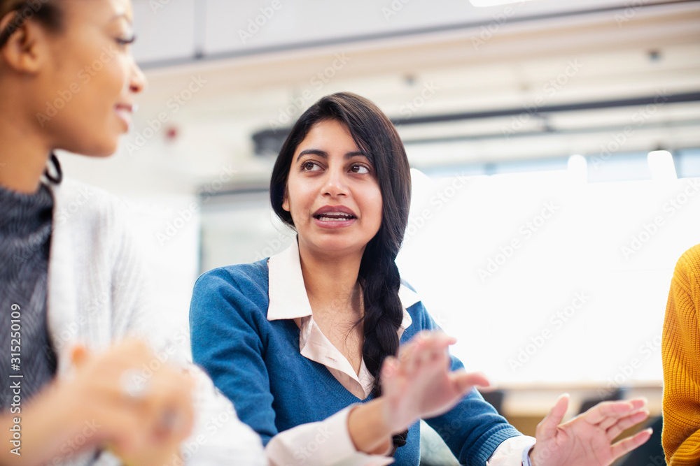 Businesswoman talking in meeting Businesswoman talking in meeting