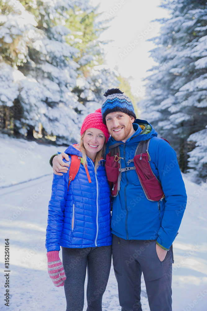Portrait couple hiking in snow Portrait couple hiking in snow