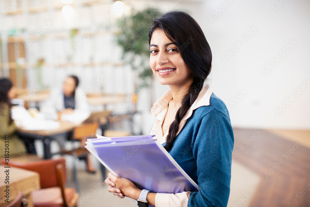 Portrait confident, happy businesswoman in office