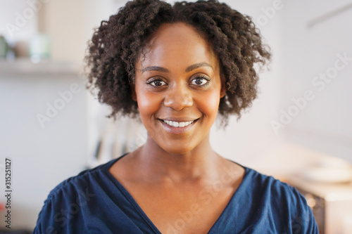 Portrait beautiful smiling woman with short black curly hair photo
