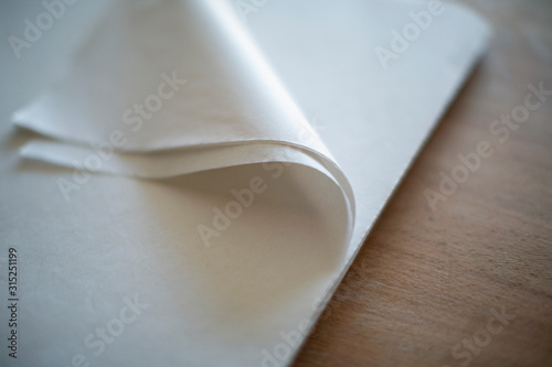 Close up folded corner of white tissue paper