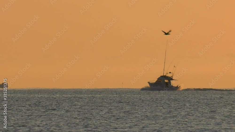 Sport fishing boat at daybreak on calm sea, mediterranean, slow motion Sport fishing boat at daybreak on calm sea, mediterranean, slow motion