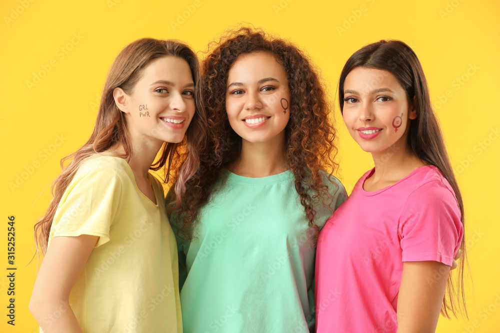 Young women on color background. Concept of feminism Young women on color background. Concept of feminism