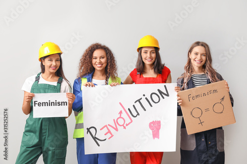 Female workers with poster ...