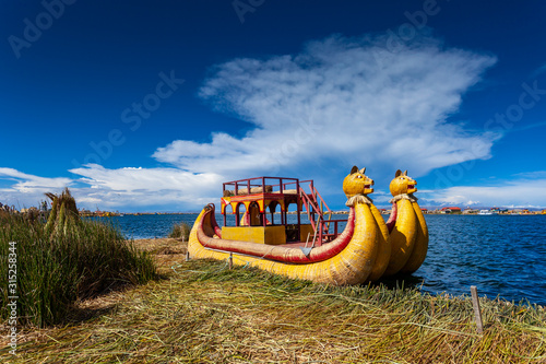 Close-up traditional reed boat as transportation for tourists, floating Uros islands on lake Titicaca in Peru, South America.
