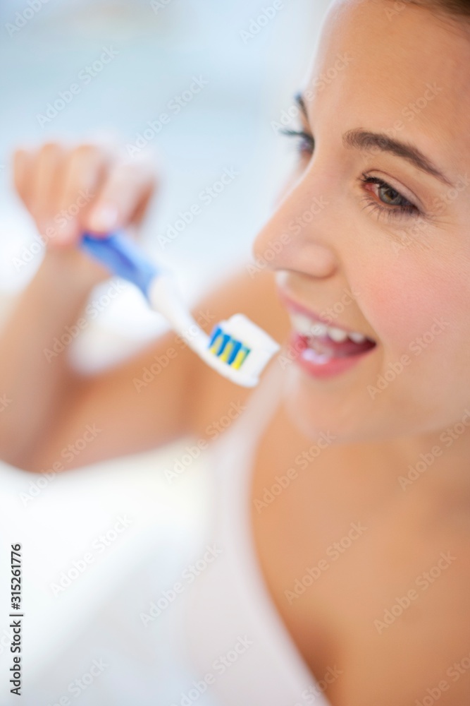 Woman brushing teeth