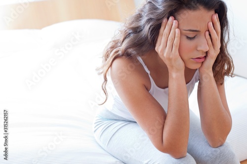 Woman on bed in pain photo