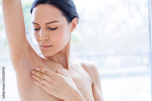 Woman touching her underarm