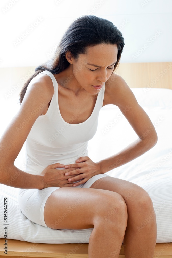 Young woman with stomach cramps Young woman with stomach cramps