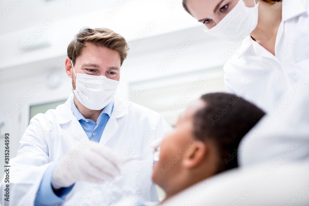 Dentist examining patient Dentist examining patient