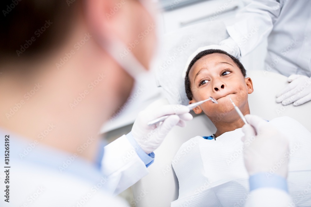 Boy rejecting dental treatment Boy rejecting dental treatment