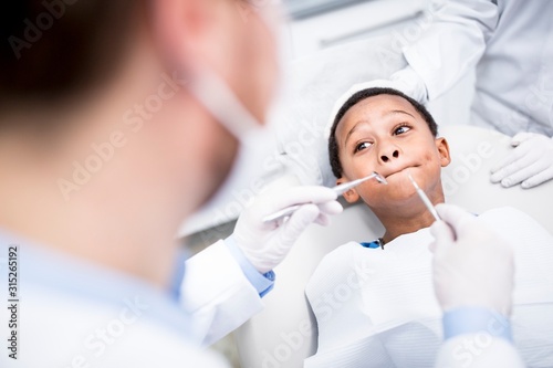 Boy rejecting dental treatment photo