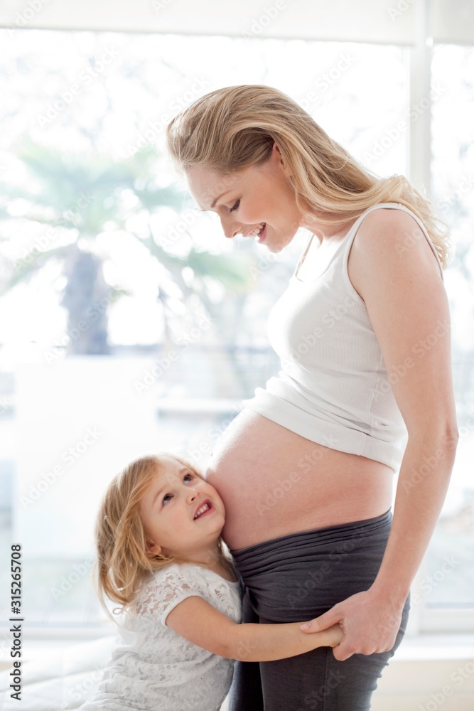 Girl with pregnant mother Girl with pregnant mother