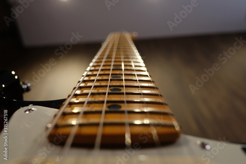 close up detail of fingerboard guitar , electric guitar instrument for musician, with selective focus.