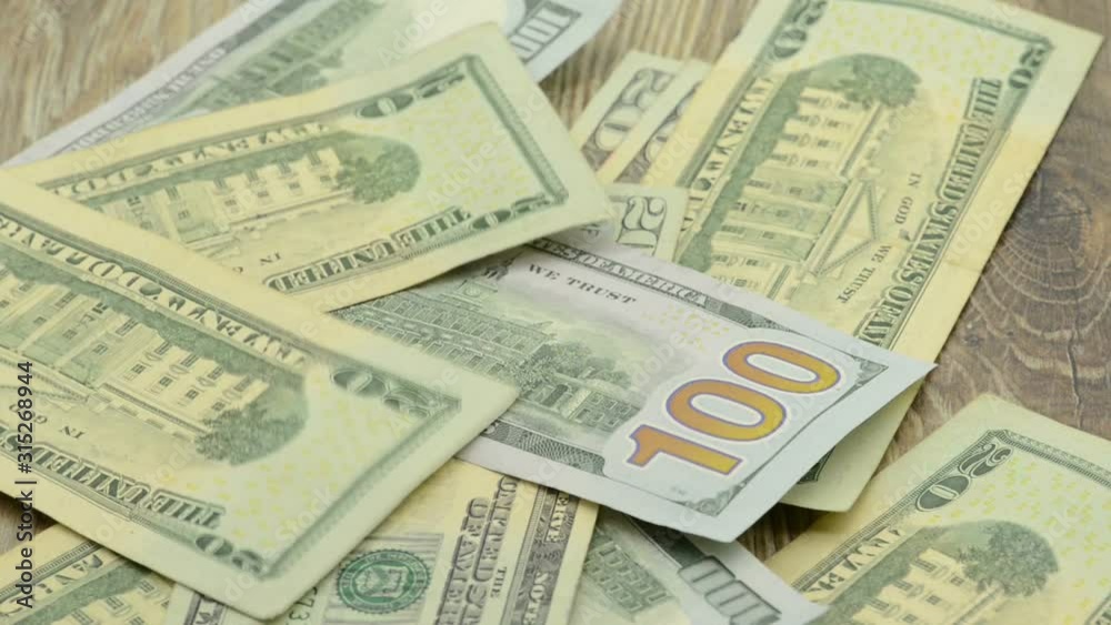 putting an amount of US dollar bank notes on table. putting an amount of US dollar bank notes on table.