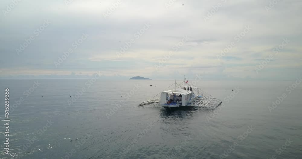 Aerial fly over a traditional boat at sea in the philippines Aerial fly over a traditional boat at sea in the philippines