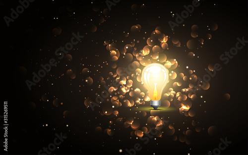 Light bulb on the golden glitter abstract background