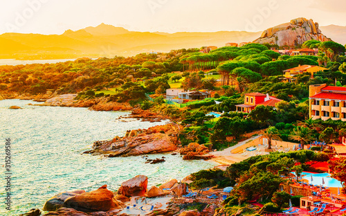 Fototapeta Naklejka Na Ścianę i Meble -  Landscape and scenery of Baja Sardinia luxury resort in at sunset evening, Sardegna island in Italy in summer. Olbia province. Villas And Mediterranean sea. Mixed media.