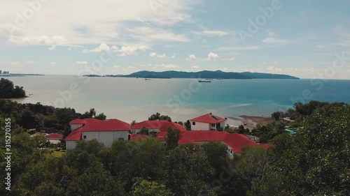 Flying over tree and beautiful seaside background. A view in Universiti Malaysia Sabah. photo