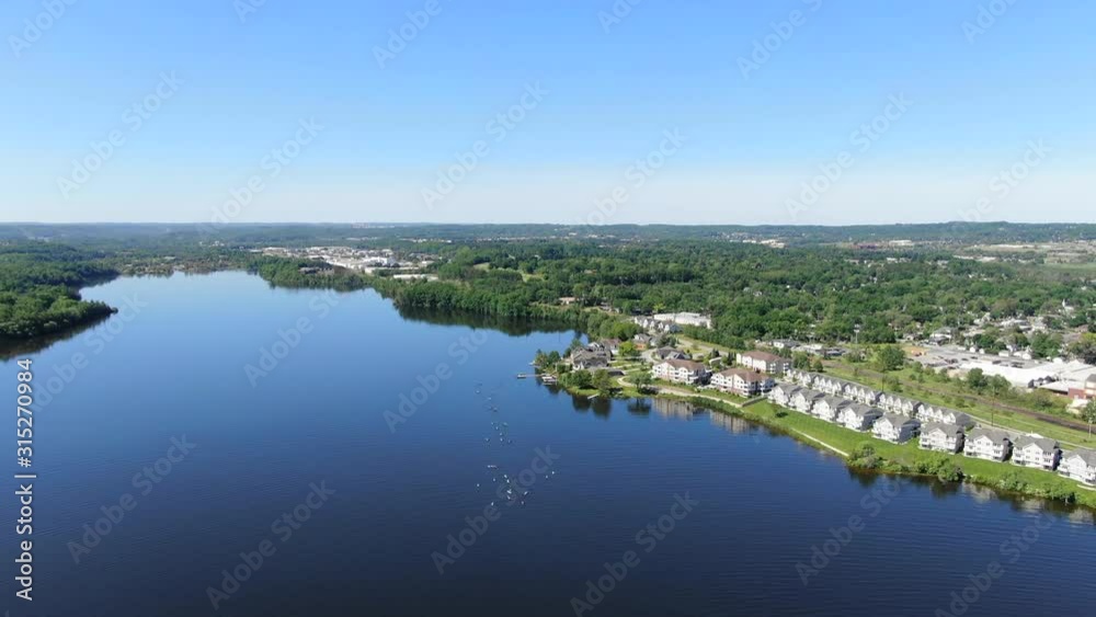 Group Kayaking in Traverse City Northern Michigan with blue sky clear fresh water people having lots of fun in the sun vacation travel trip up north for the summer warm activities blue water fun