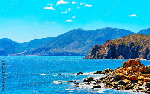 Fototapeta Naklejka Na Ścianę i Meble -  Landscape with Capo Pecora beach at the Mediterranean Sea in Buggerru in South Sardinia of Italy. Scenery Sardinian Italian resort with yellow sand in Sardegna. Mixed media.