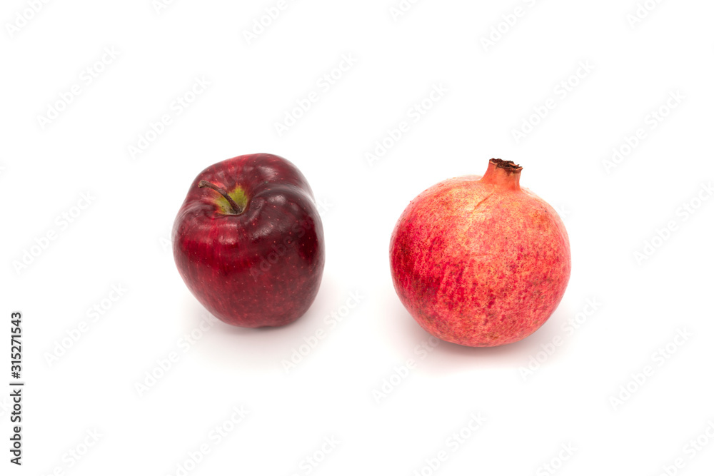 Pomegranate and red apple isolated on white background Pomegranate and red apple isolated on white background