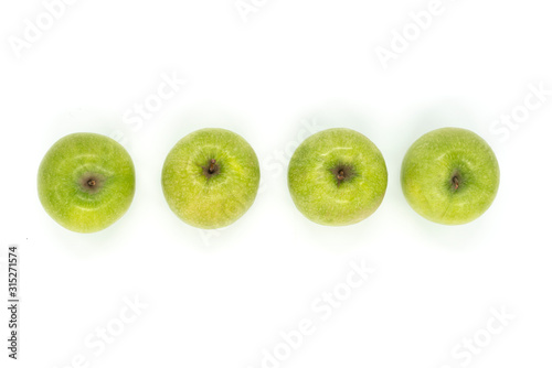 Four green apples isolated on white background